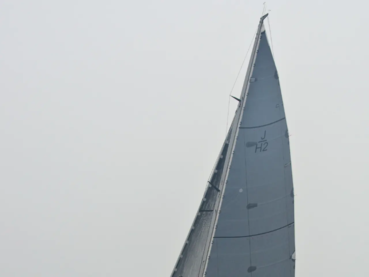 In this image we can see ship with persons on the water and sky in the background.