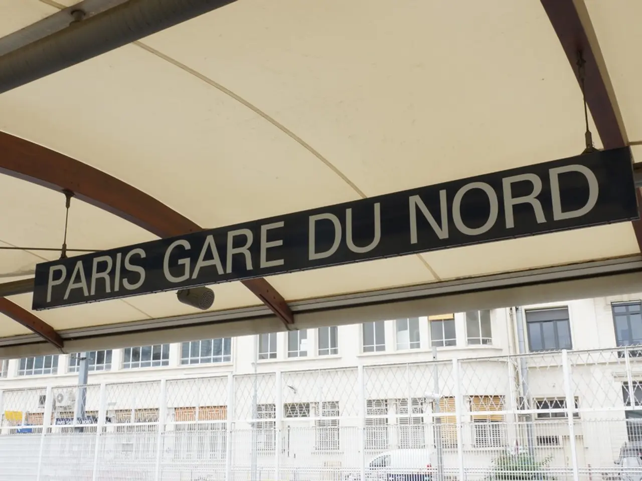 In this picture there is a text on the board and there is a board under the roof. At the back there...