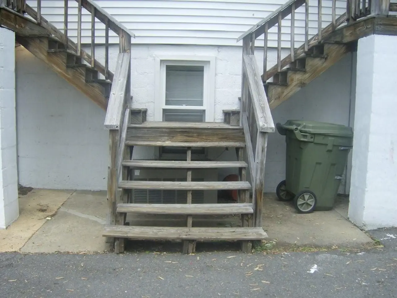 There is a road. Beside this road, there are wooden steps having wooden fences on both sides. These...