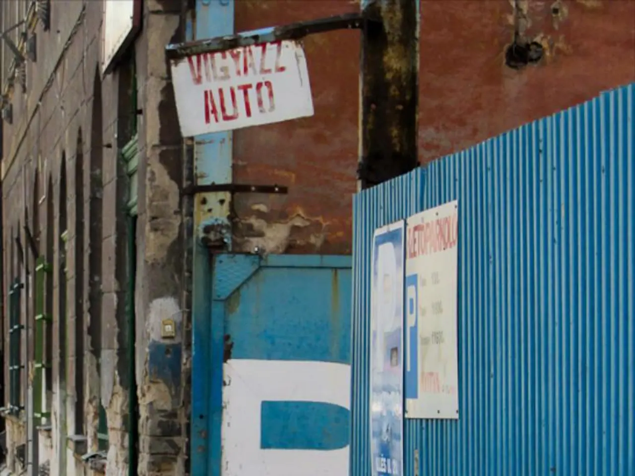 In this picture we can see a building,, on the right side we can see a blue color sheet and three...