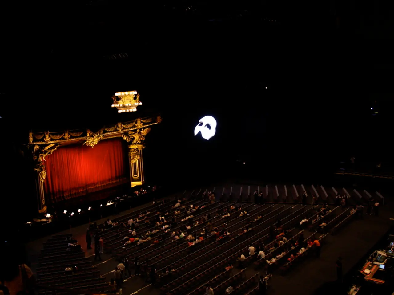 In this image there is a seating are in middle of this image and there are some persons are sitting...