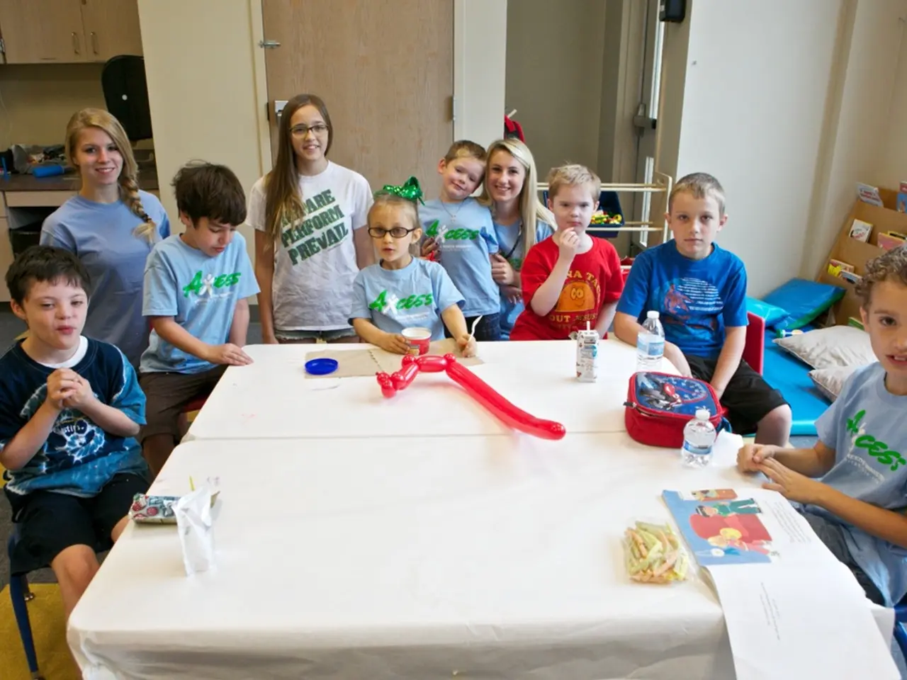 In this image I see number of children and 3 women over here and few of them are smiling. In the...