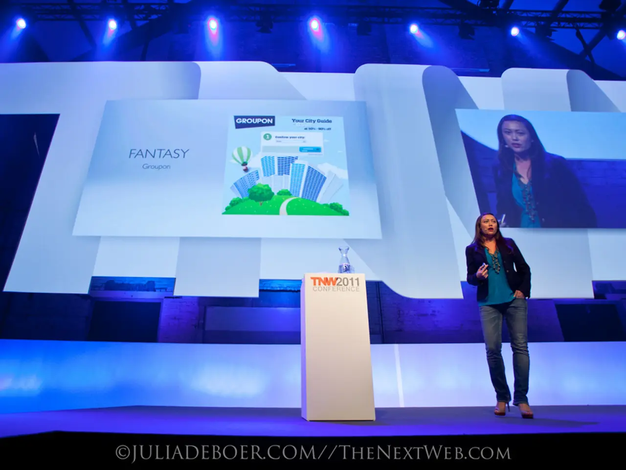 This image consists of a woman standing on the dais and speaking. In the middle, there is a podium....