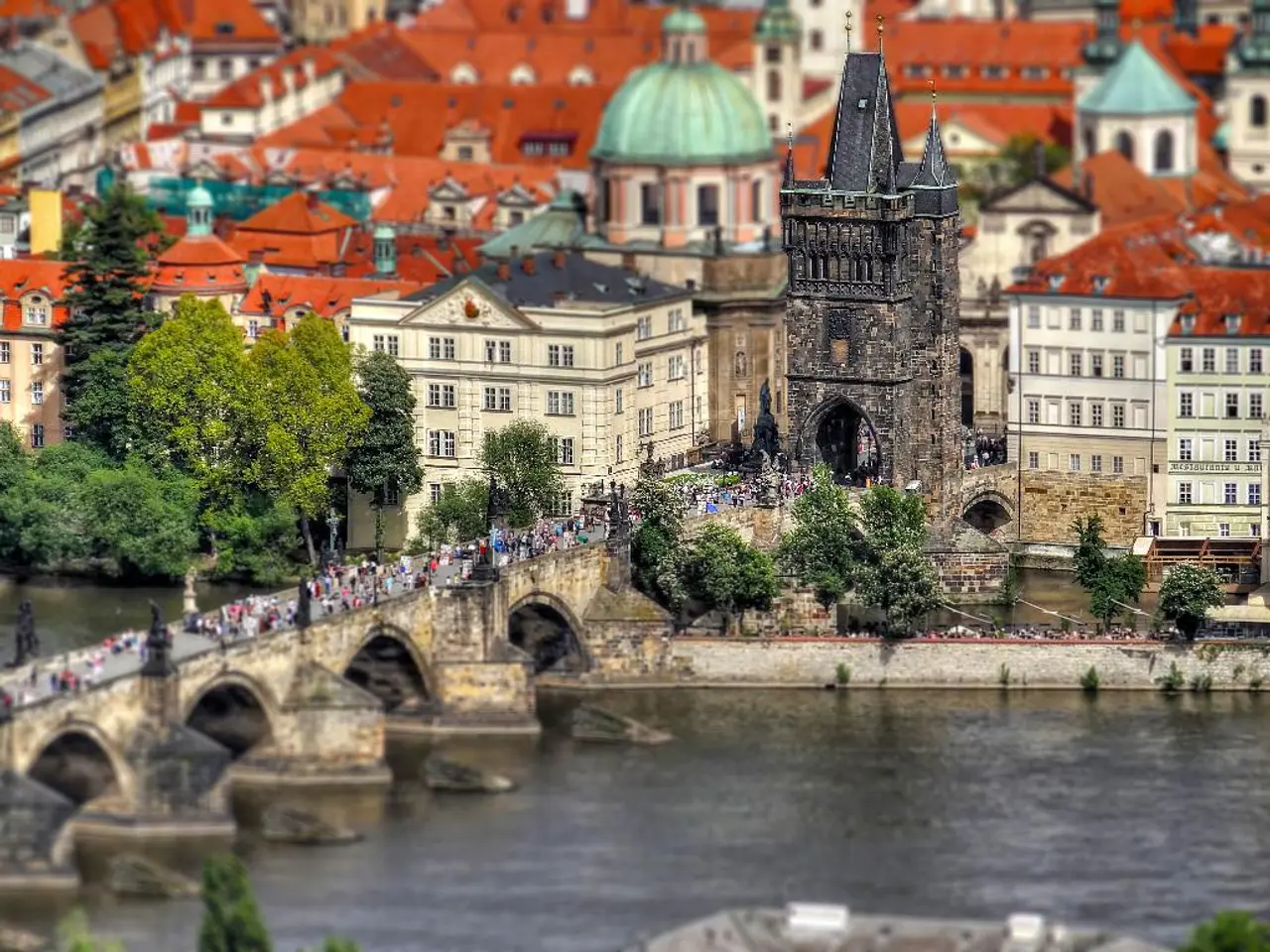 In this image there are many buildings and also tower. Image also consists of trees and many...