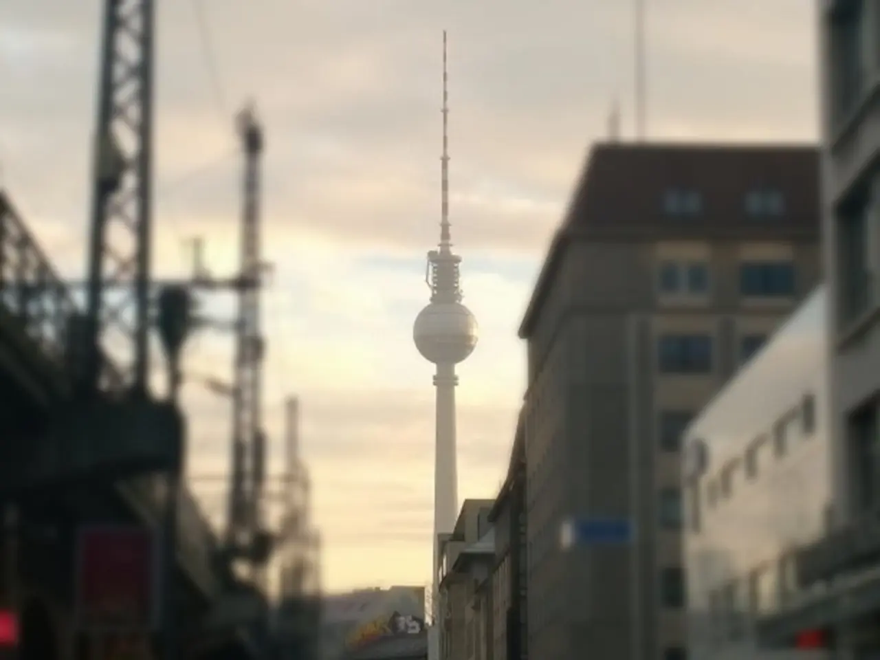 In this image we can see street road and there are some cars parked, there are some buildings on...