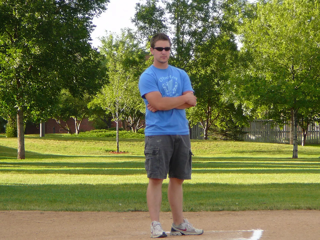 In the image there is a man standing on the ground and behind him there is a garden and there are...