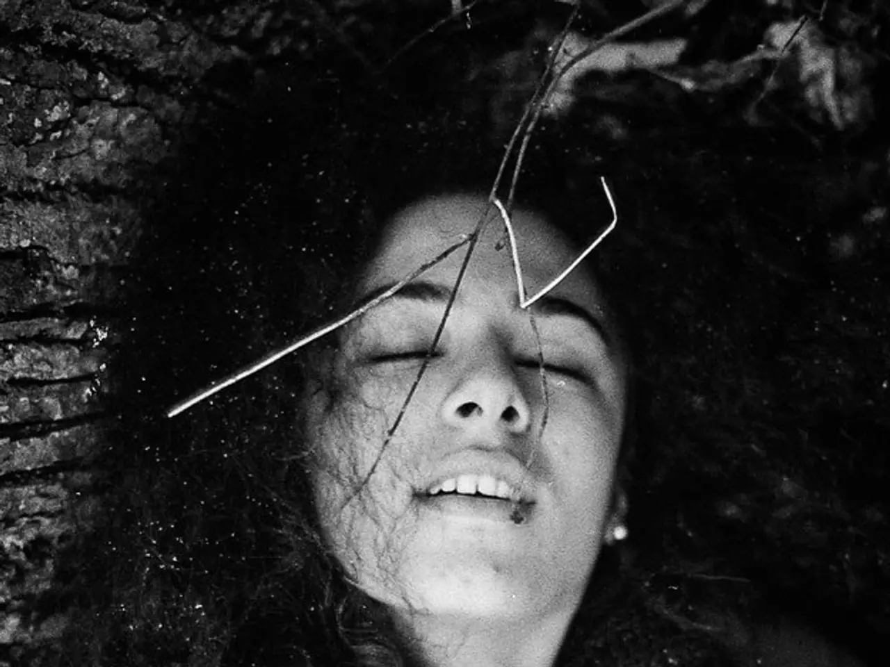 This is black and white image where we can see a girl. She is wearing jacket and woolen scarf.