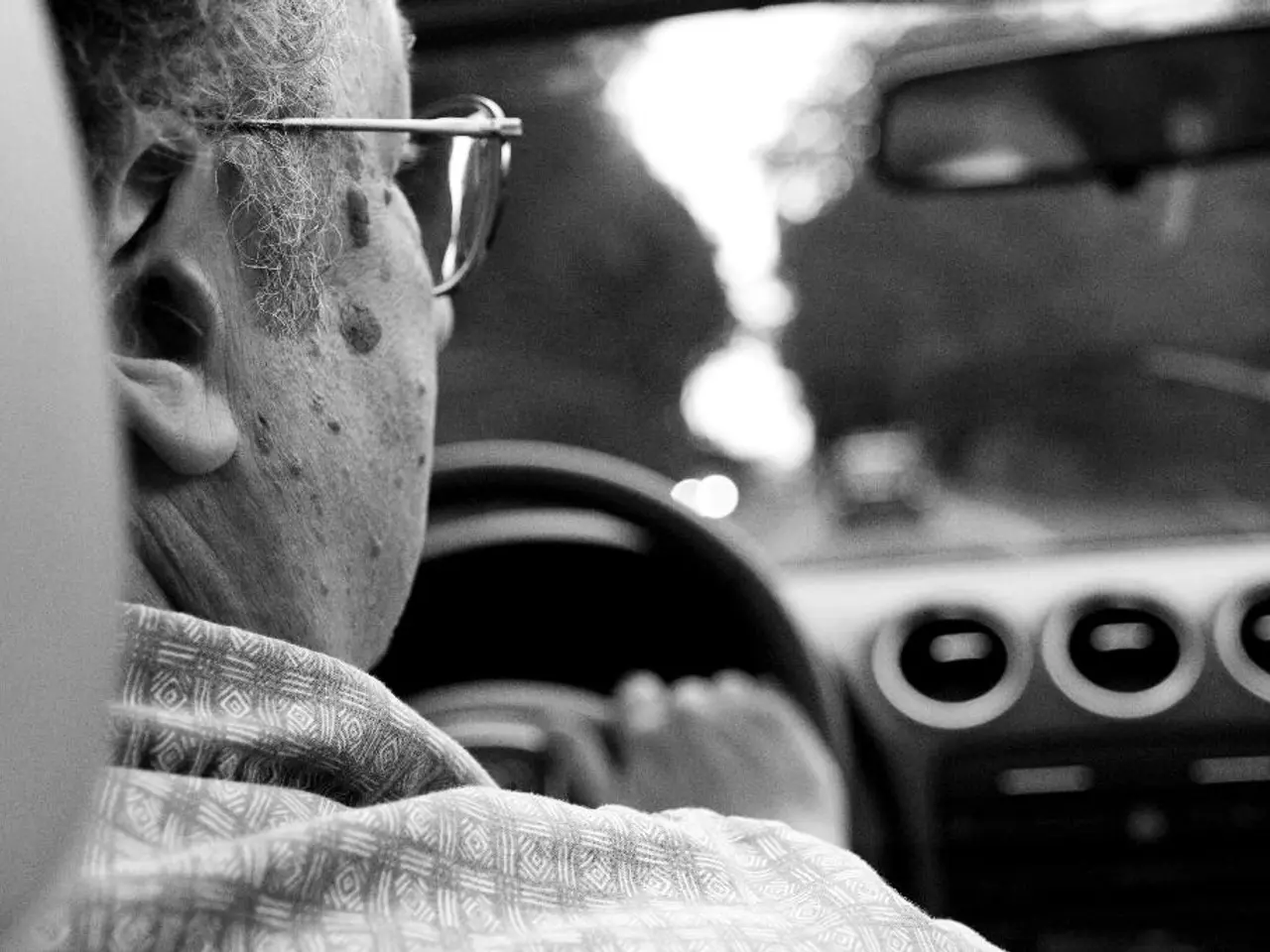 On the left side, there is a person, wearing spectacle, sitting on a seat and driving this vehicle...