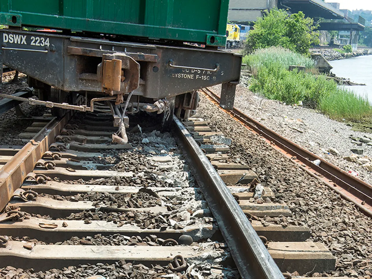 In this image, we can see a railway track and there is a train on the track, at the right side...