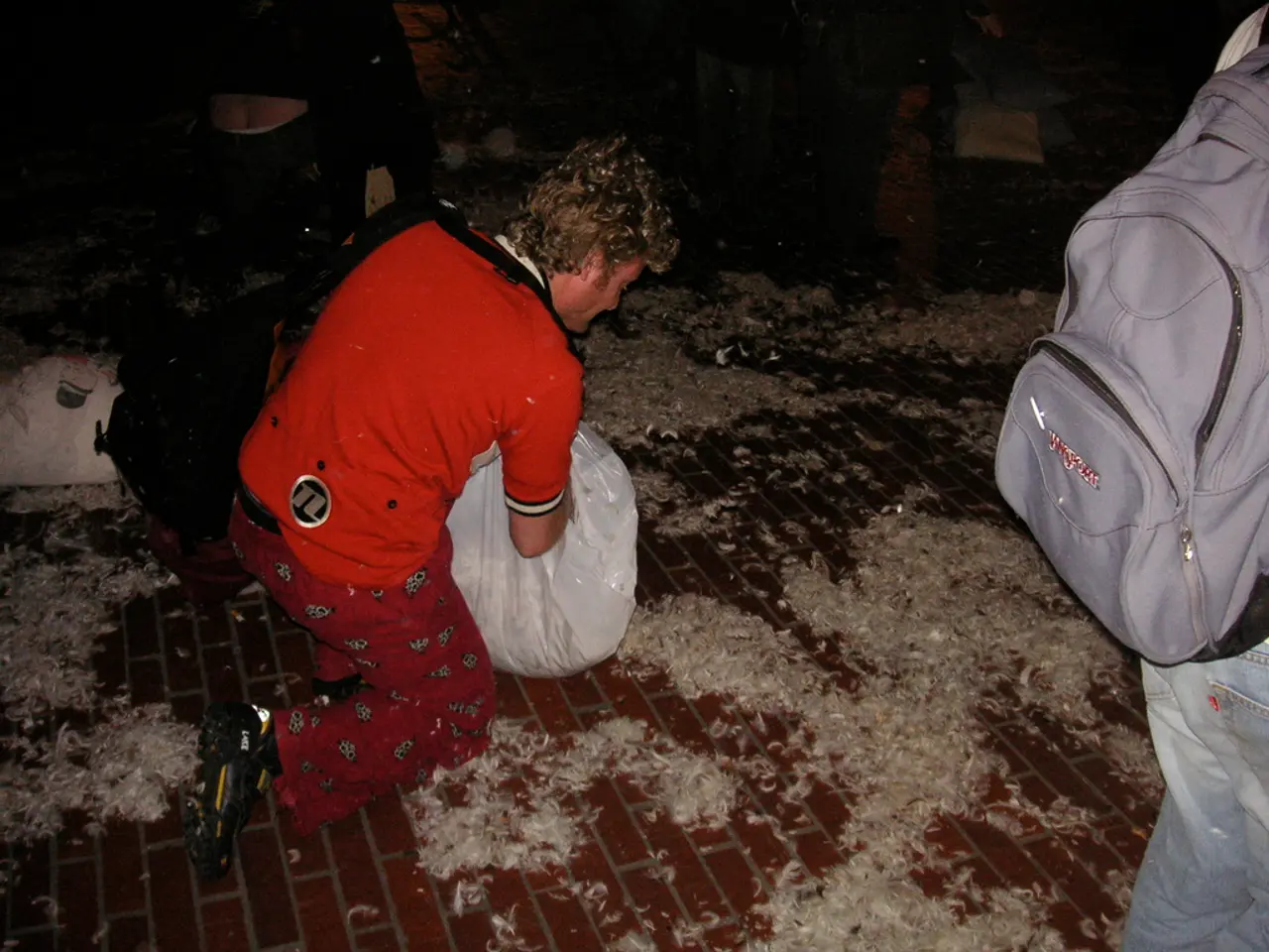 In this image we can see a man. He is wearing T-shirt, pant, jeans and carrying bag. There is a...