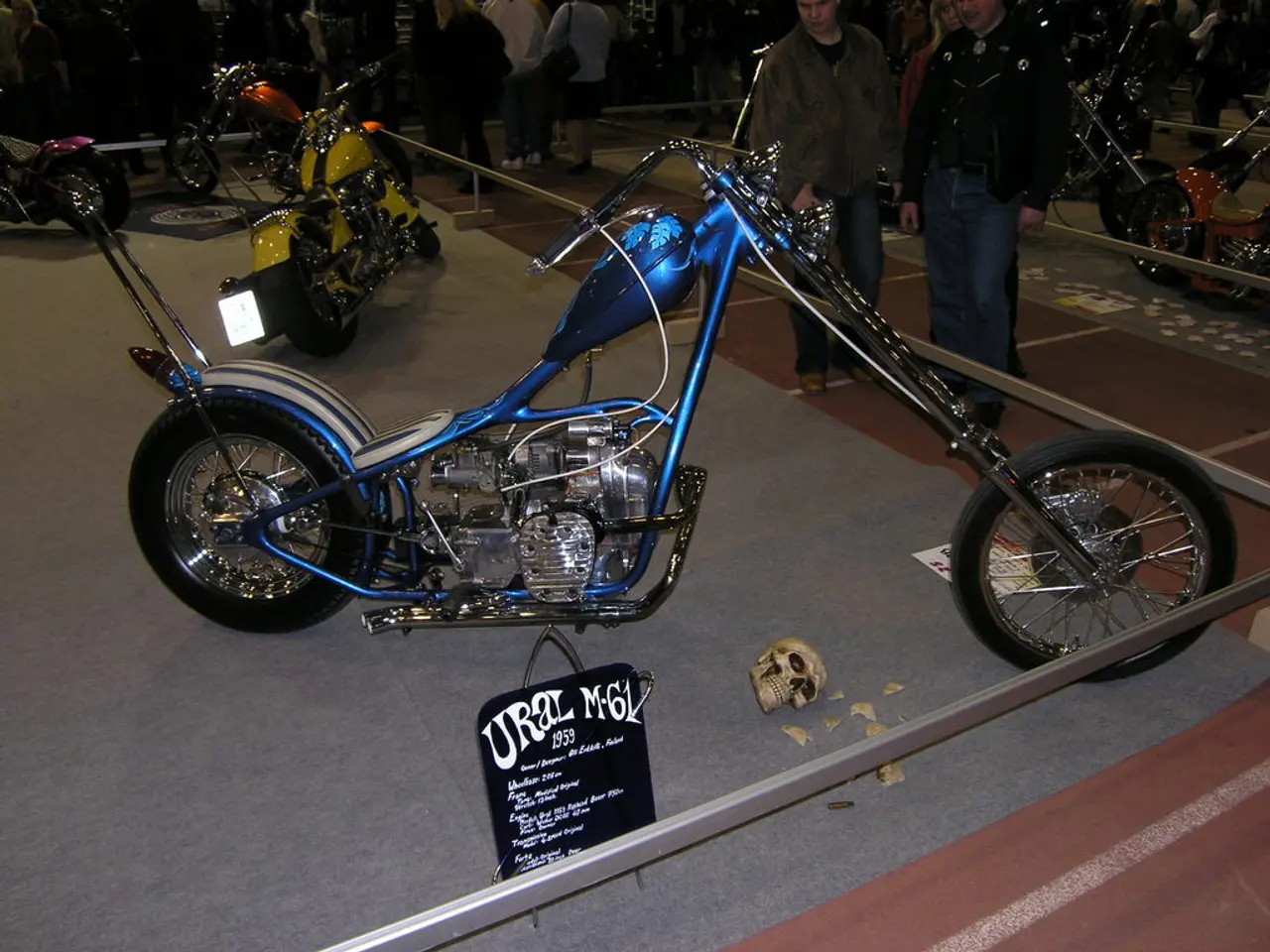 In front of the image there are motorbikes inside the fencing. And there is a skull and a poster...