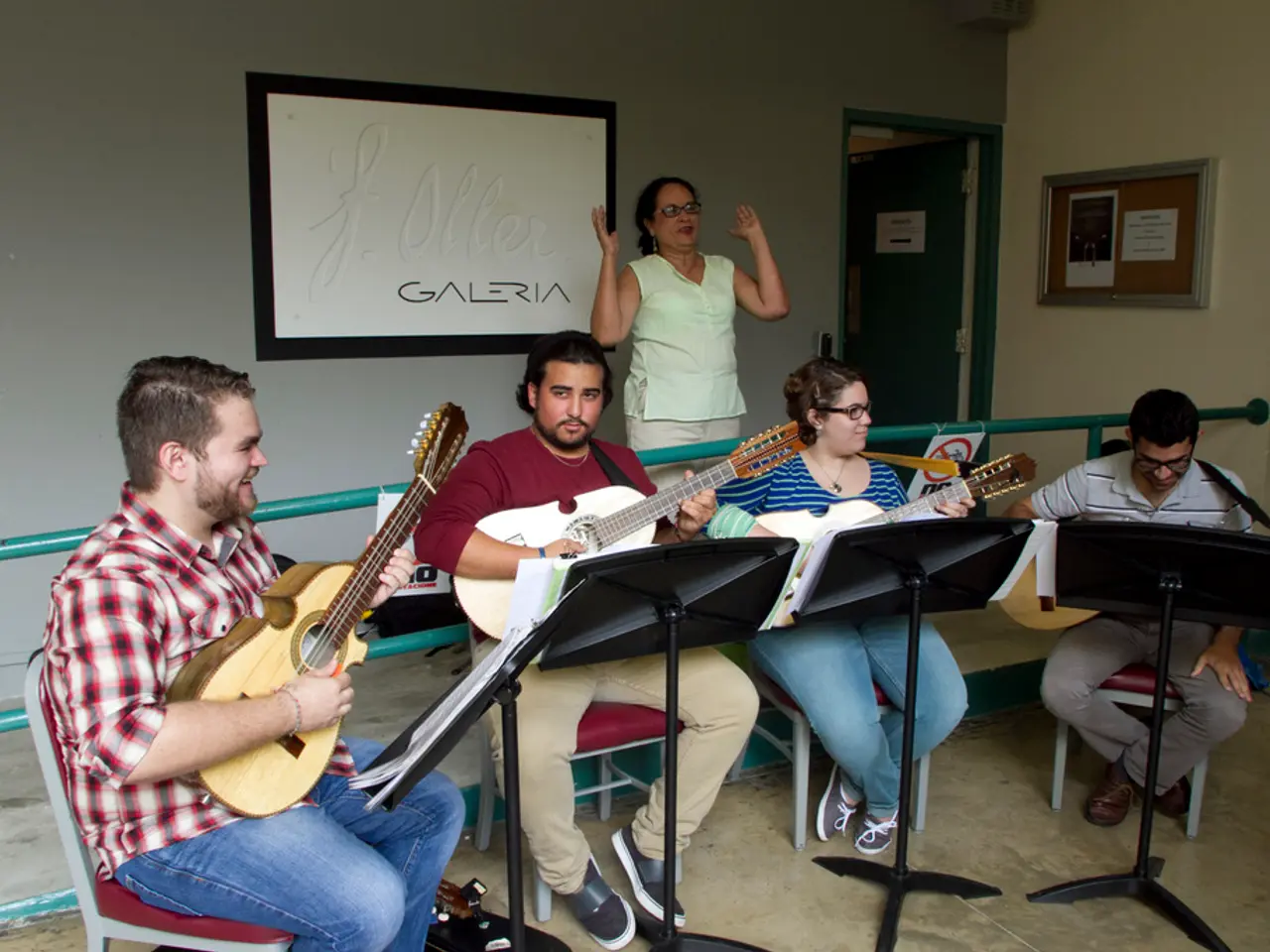This a picture in a music class, there is a women standing and giving the instructions to the music...