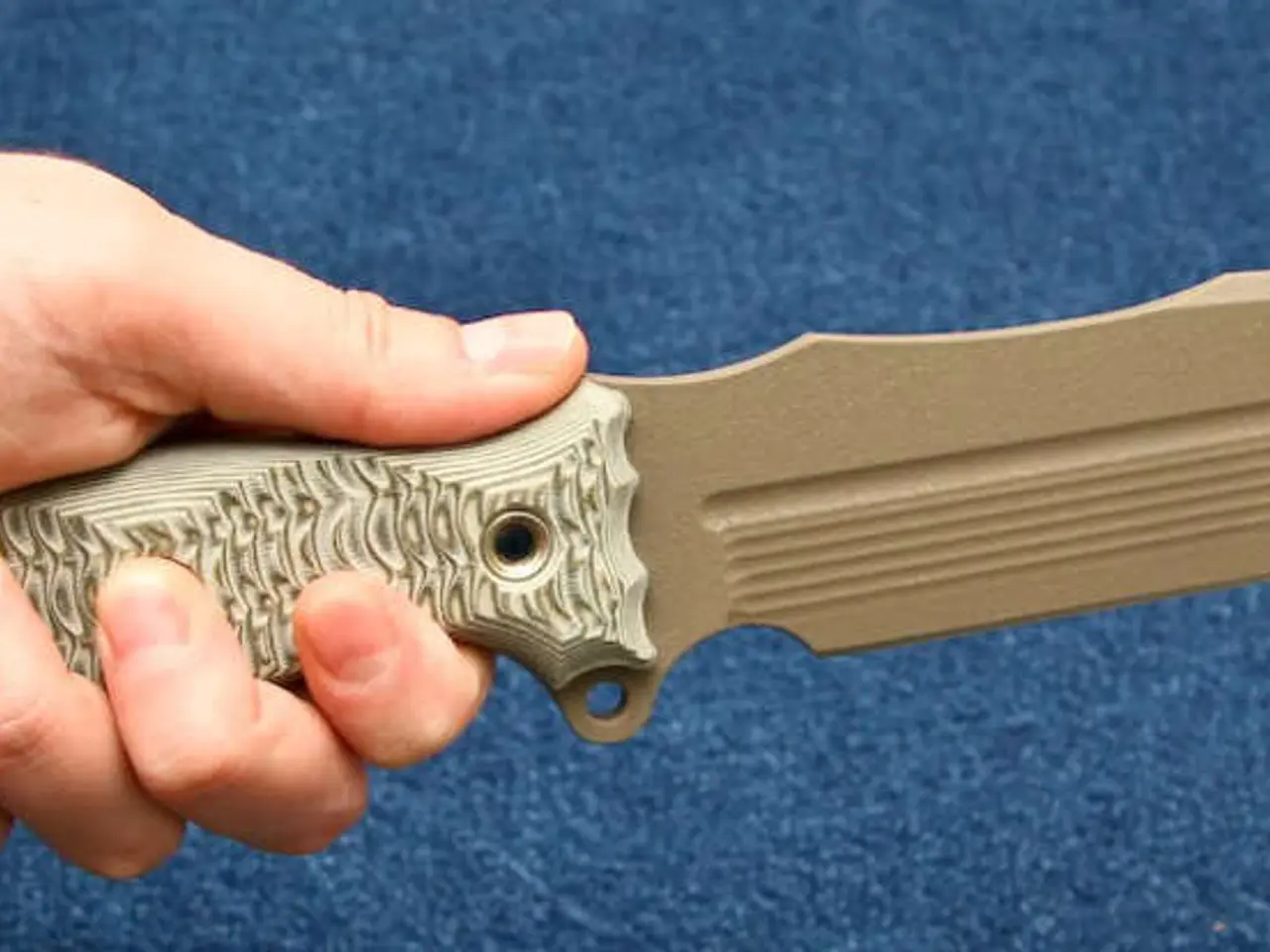 In this image I can see a person holding a knife.