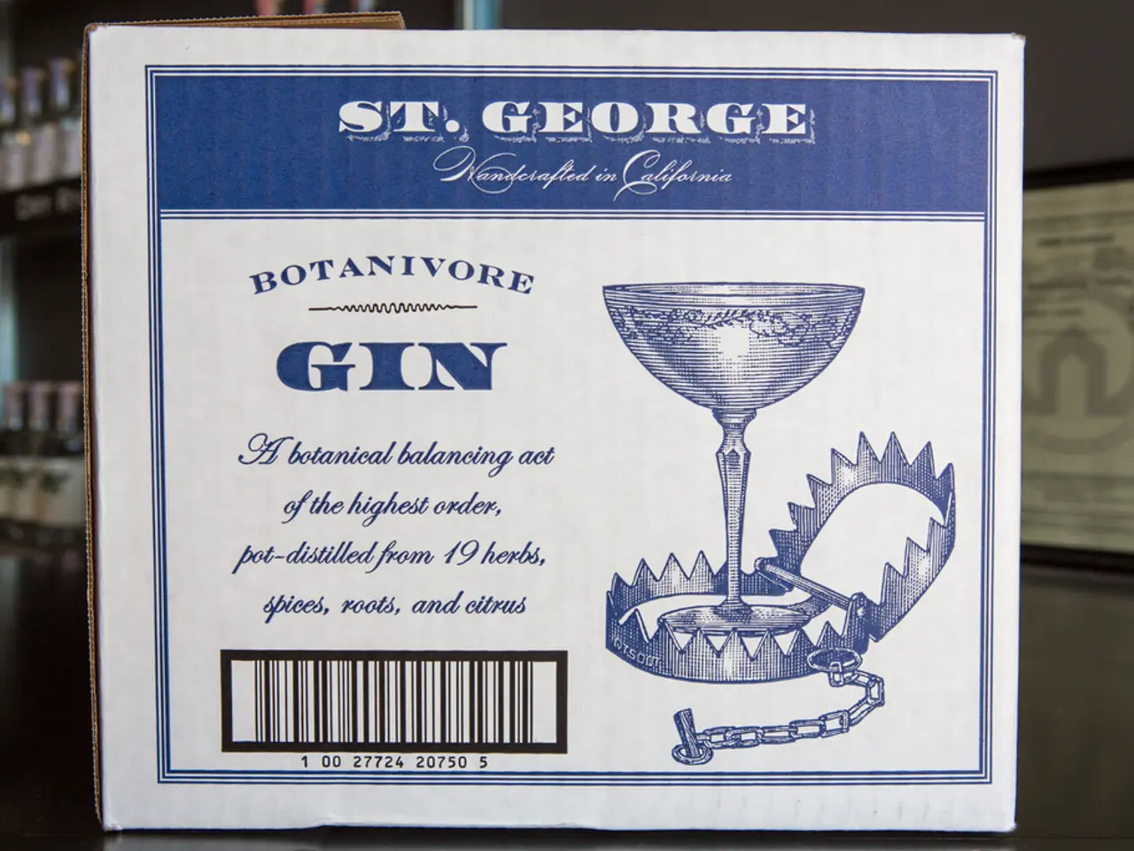 In the picture there is a poster with the text, behind there are many bottles present on the...