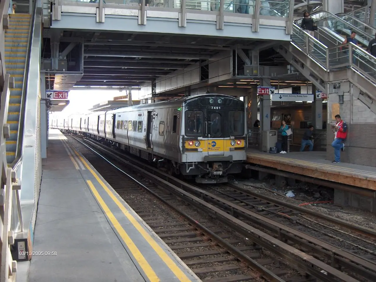 In this picture we can observe a railway station. There is a train on the railway track. We can...