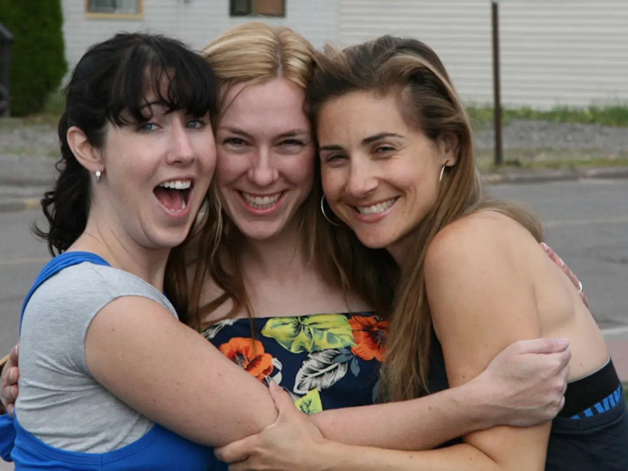 In the image there are three women standing in the front and smiling and behind them there is hope...