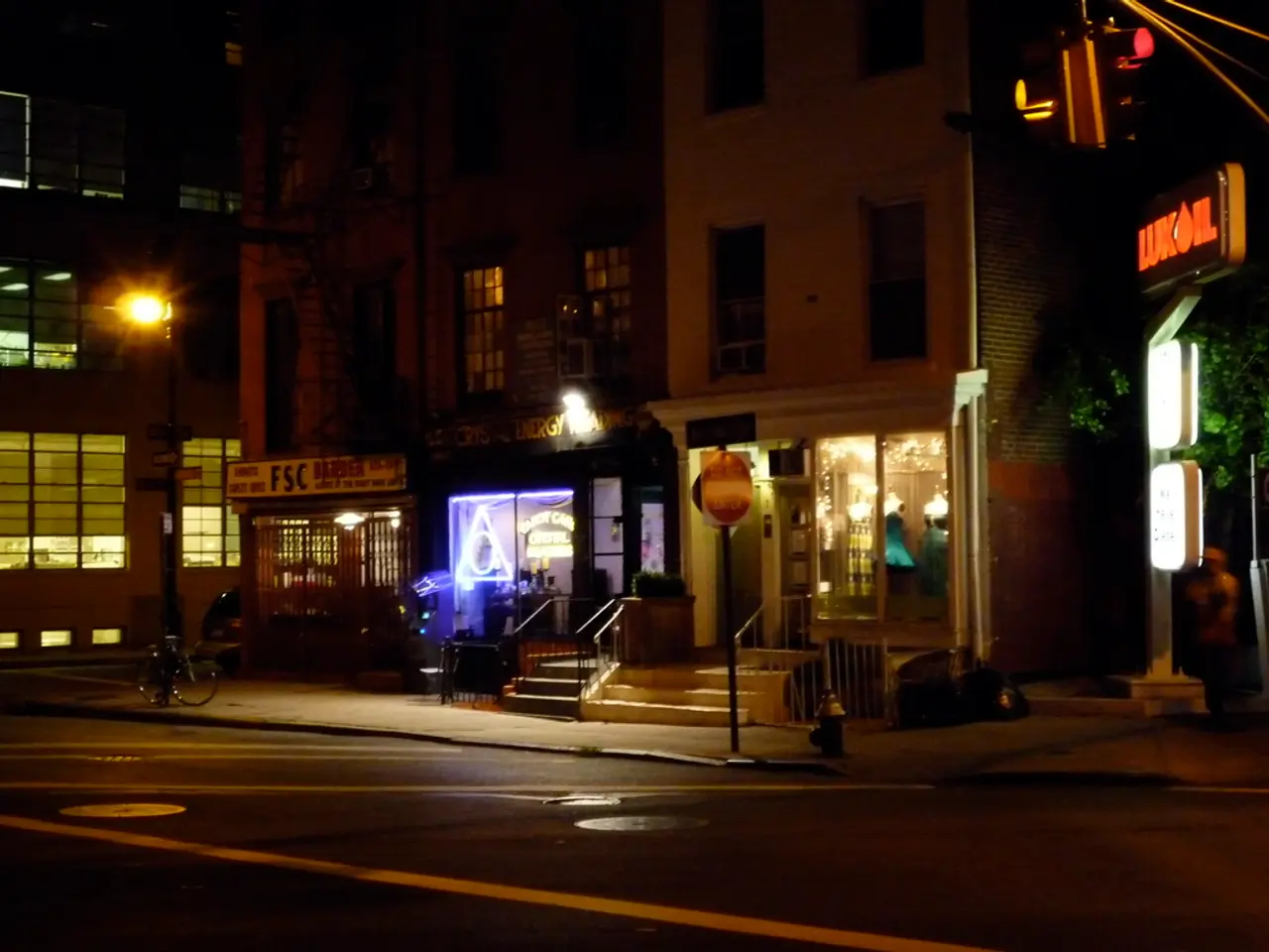 In this image we can see buildings, lights, stores, stairs, trees, road, bicycle and traffic...