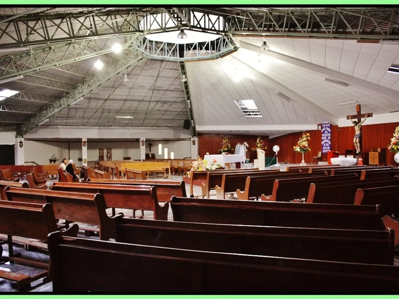 This is an inside view of the church and here we can see benches and some people sitting on the...