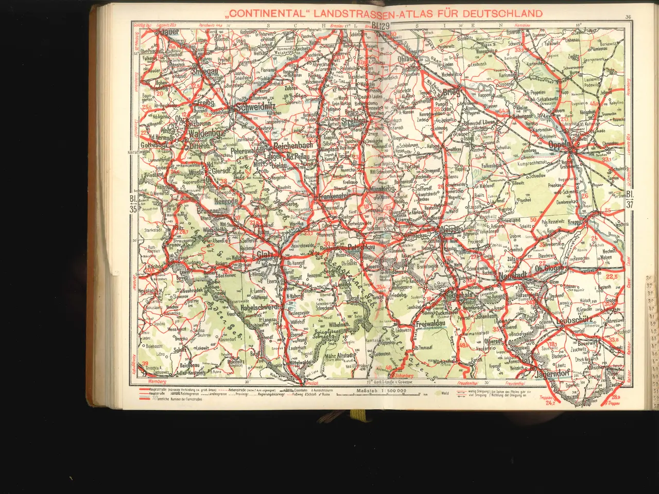 The image shows an open book with a map of Germany on it, set against a black background. The map...