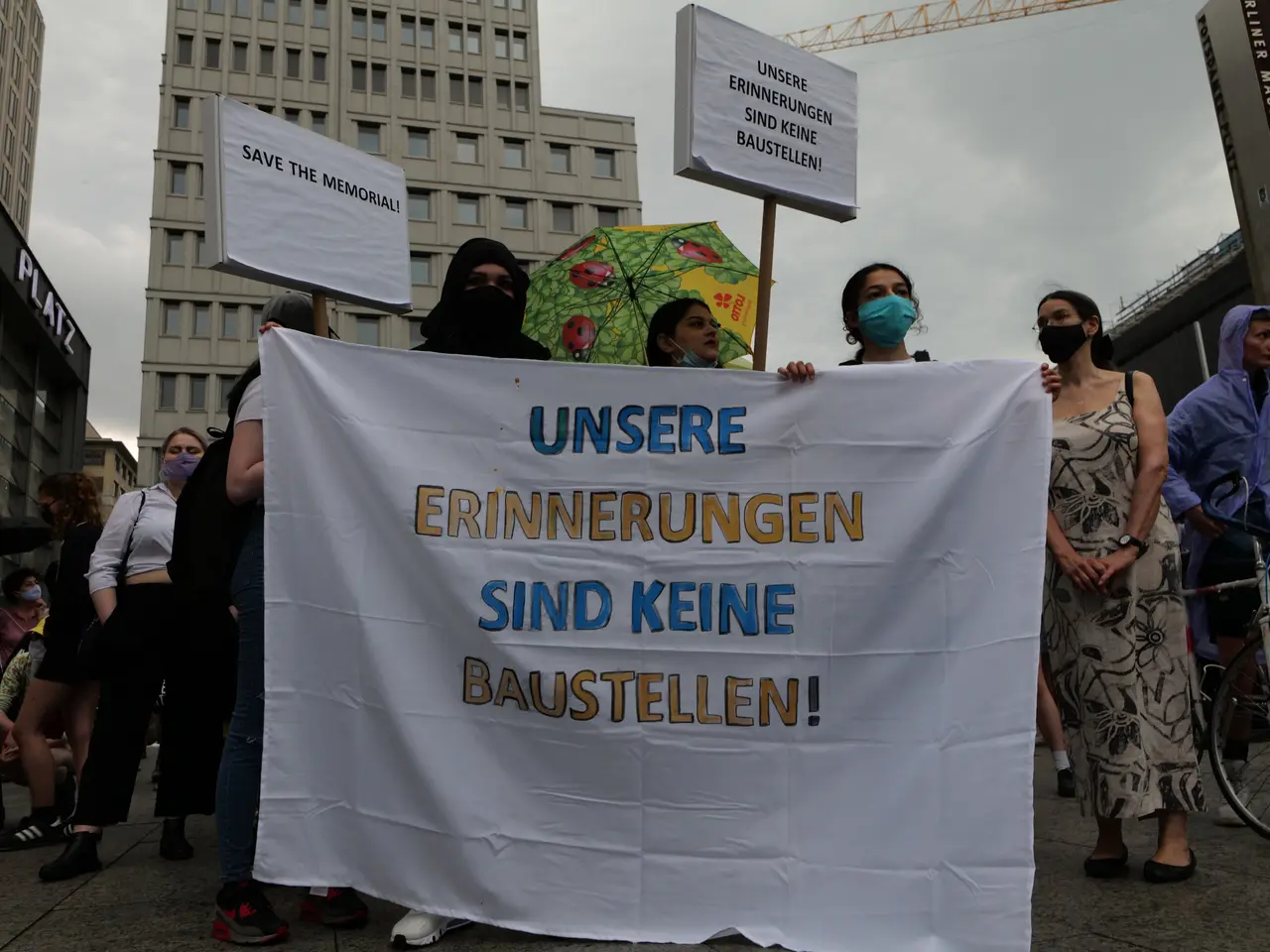 The image shows a group of people wearing masks and holding a banner that reads "Unsere...