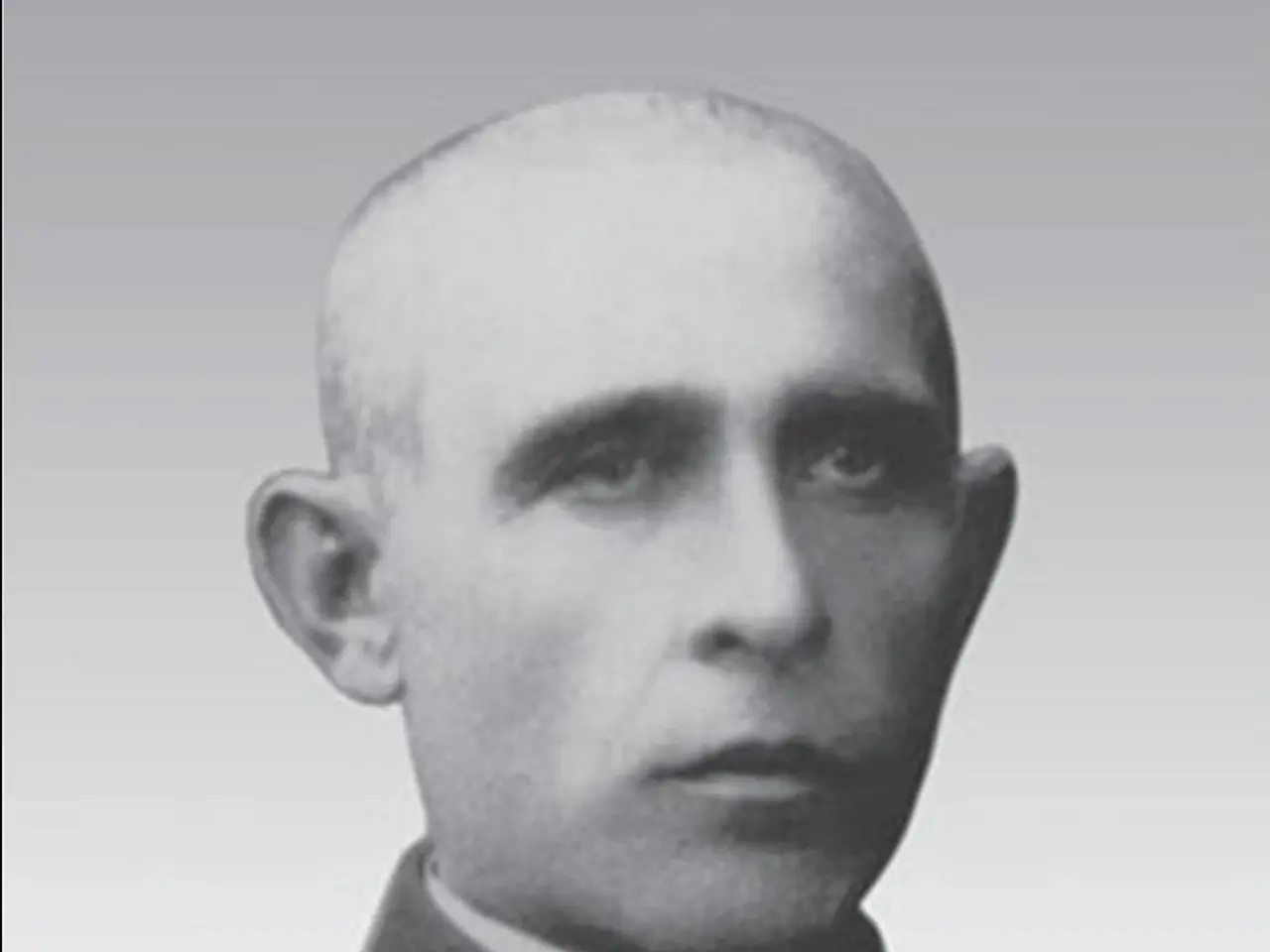 The image shows a black and white photo of a man in a priest's robes, with a white background. The...