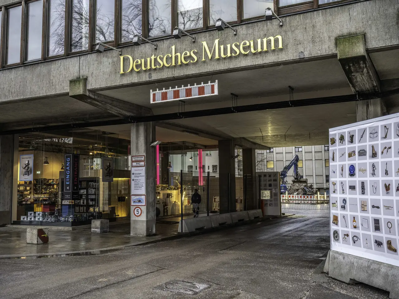 The image shows the Deutsches Museum in Berlin, Germany. It is a large building with glass windows,...