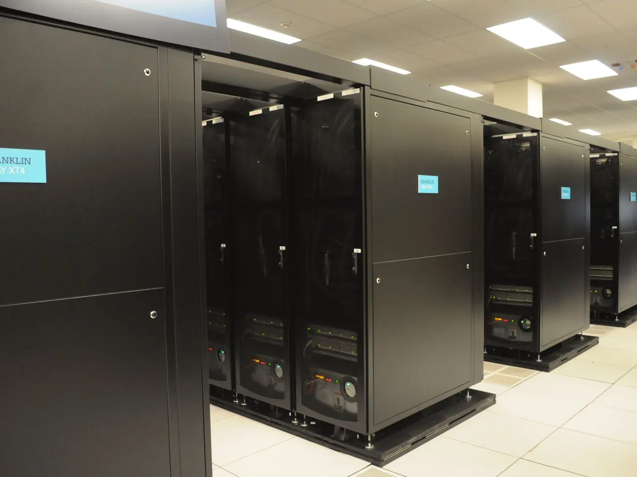 The image shows a large room filled with lots of servers, with a floor at the bottom, a ceiling...