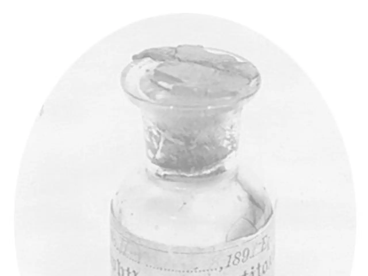 The image shows a small glass bottle with a white label on it, which reads "Antibiotics in...