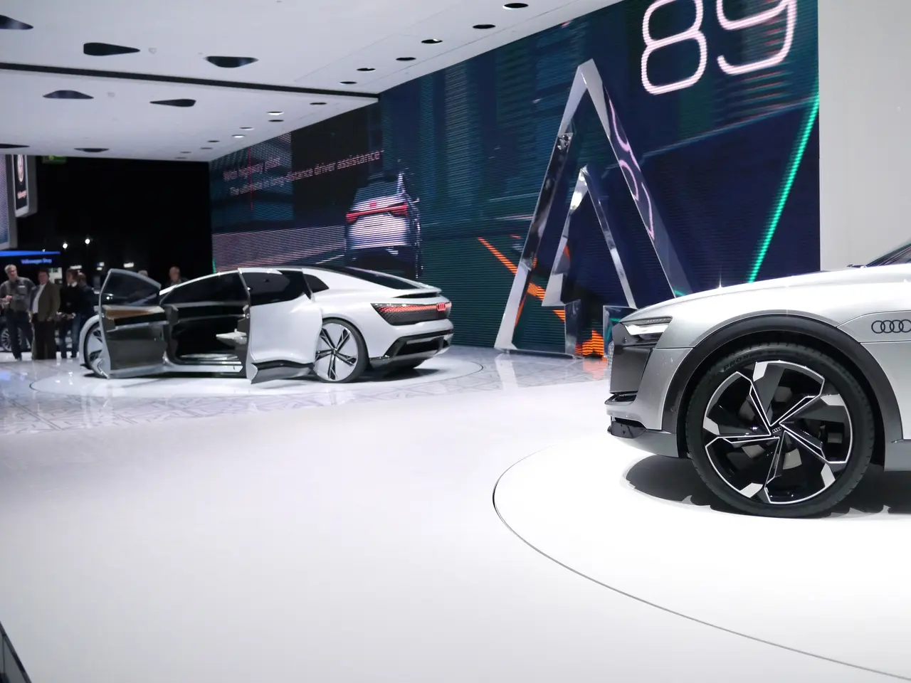 The image shows an Audi e-tron concept car on display at the Frankfurt Motor Show, surrounded by a...