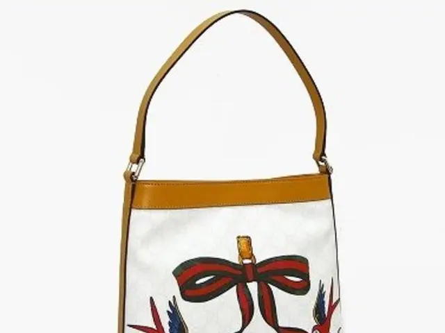 In this image there is one hand bag and on that hand bag there is some painting.