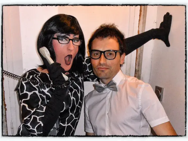 In this image there are persons in the center and the person on the left side standing and holding...