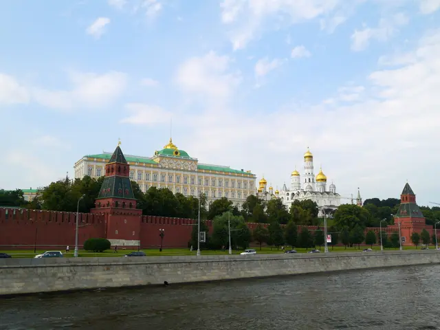 At the bottom of the image I can see water. In the middle of the image I can see vehicles. In the...