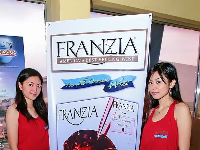In this picture we observe two women are standing beside a poster on which Franzia Americas best...