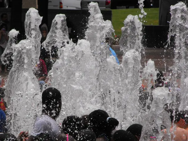 There are few persons and there is water on the either sides of them and there are vehicles in the...