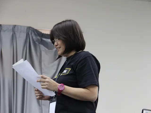 In the image we can see a woman standing, wearing clothes, spectacles, wrist watch, identity card...