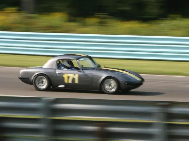 In this image on a road a car is moving inside it a person is sitting wearing helmet. In the both...