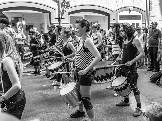 It seems to be the image is outside of the city. In the image there are group of people standing...