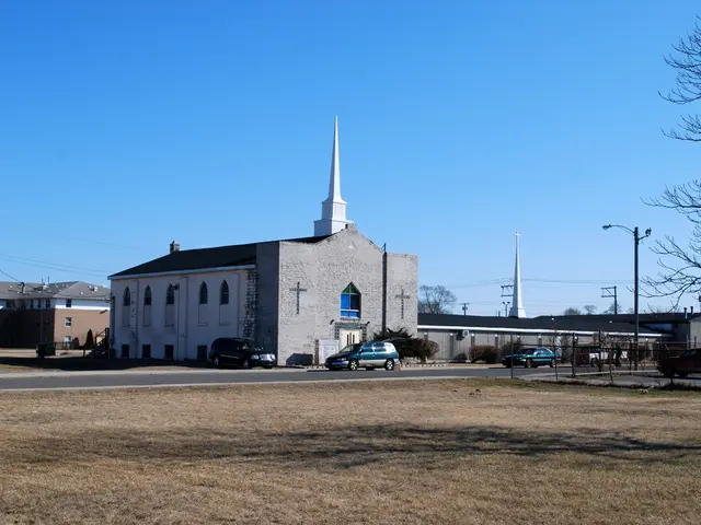 In this image there are so many buildings, beside that there are some cars on the road and trees at...