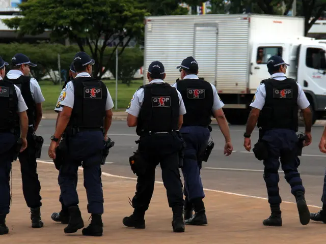 In this picture we can see the group of officers who are wearing cap, shirt, bulletproof jackets,...