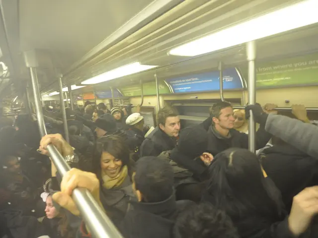 This picture seems to be clicked inside the train and we can see the group of people standing and...