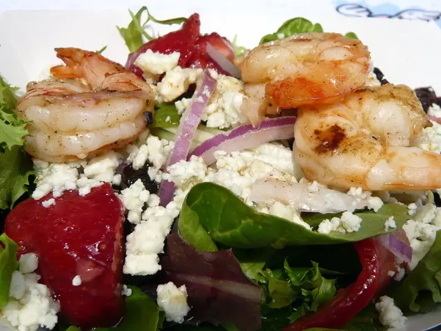 In this image at the bottom there is one plate in that place there are some prawns and some food...