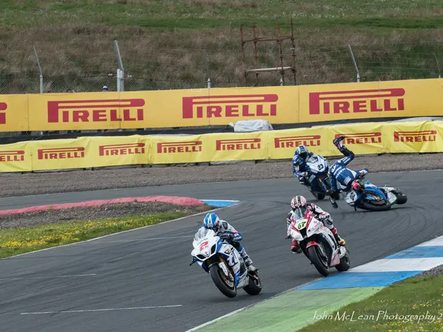 In this image I can see group of people riding bikes. In the background I can see few boards in...