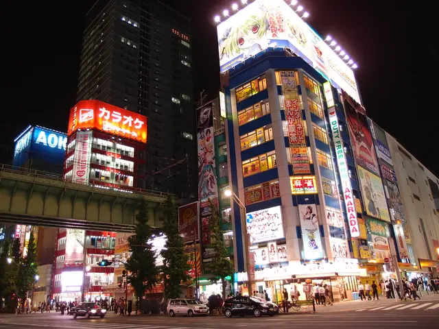 This image is clicked on the road. There are cars moving on the road. Beside the road there is a...