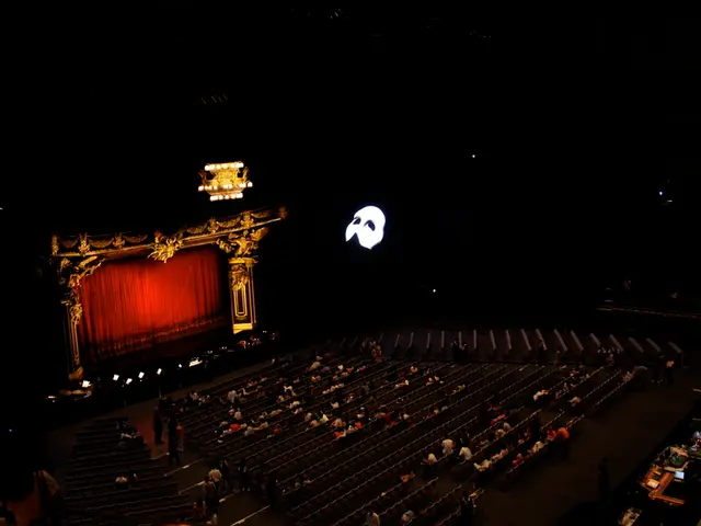 In this image there is a seating are in middle of this image and there are some persons are sitting...