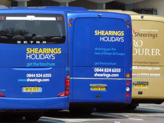 In this picture we can see three buses parked here, in the background there is a wall, we can see...