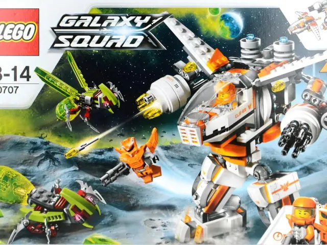 In this image we can see machines, cables, computer display, pen holder, persons and a stress ball.