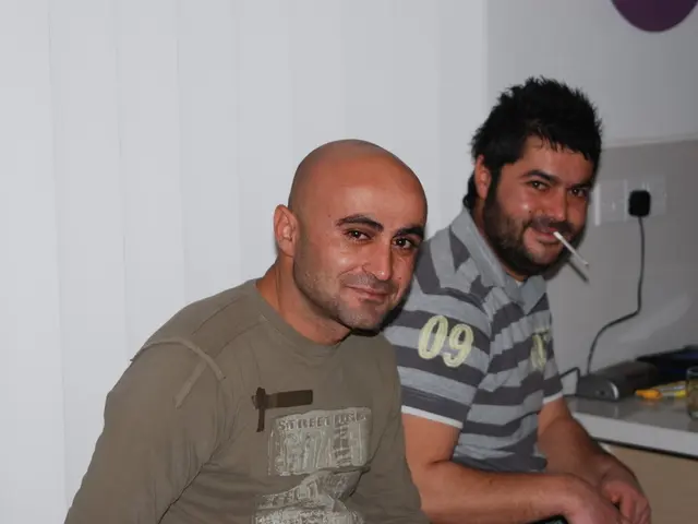 In this image we can see two plug sockets ,one is plugged in extension box and two persons are...