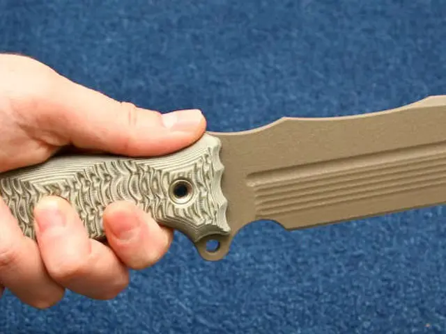 In this image I can see a person holding a knife.