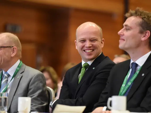 This is an inside view. Here I can see three men wearing suits, sitting on the chairs and smiling....
