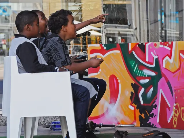 In this image I see 3 children who are sitting on chairs and I see that they're holding few things...